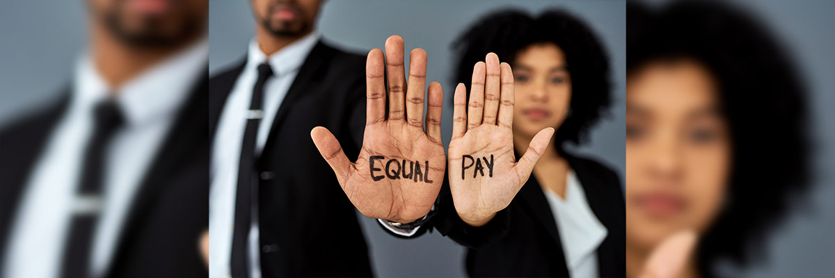 Manos Unidas por la Igualdad Salarial La imagen muestra dos individuos con “EQUAL PAY” en sus palmas, simbolizando la lucha por la igualdad salarial.