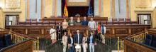 Visita al Congreso de los Diputado Grupo de visitantes en el hemiciclo del Congreso de los Diputados, foto institucional durante visita guiada.
